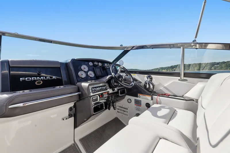 Slide: The Image of 2016 Formula 330 Crossover Bowrider cockpit with steering wheel and control panel. - 31
