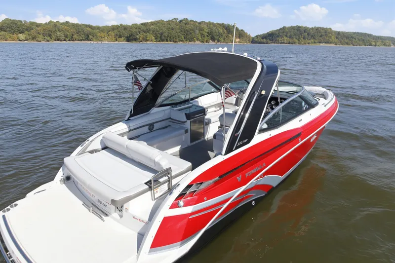 Slide: The Image of 2016 Formula 330 Crossover Bowrider in vibrant red on a serene lake. - 12