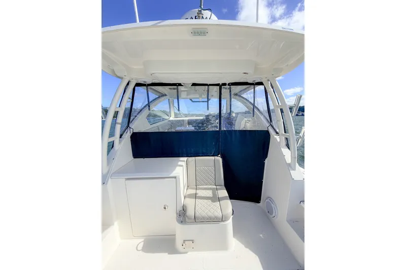 Slide: The Image of 2023 Pursuit OS 325 Offshore boat interior with seating and clear enclosure. - 4