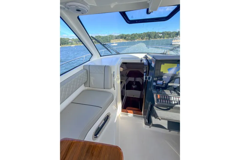 Slide: The Image of Interior view of 2023 Pursuit OS 325 Offshore boat cockpit with navigation equipment. - 8