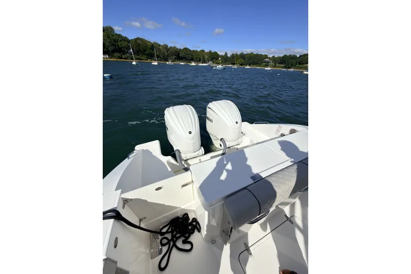 Slide: The Image of 2023 Pursuit OS 325 Offshore boat with dual engines on a sunny day. - 6
