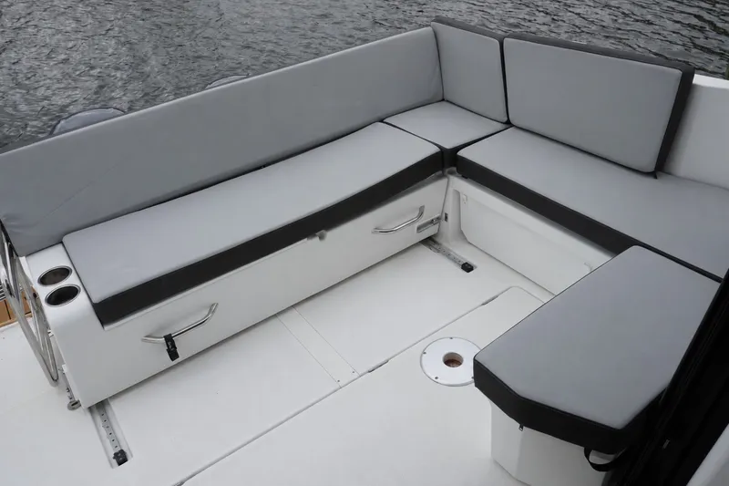 Slide: The Image of 2024 Jeanneau NC Sport 895 boat with spacious gray cushioned seating area. - 25