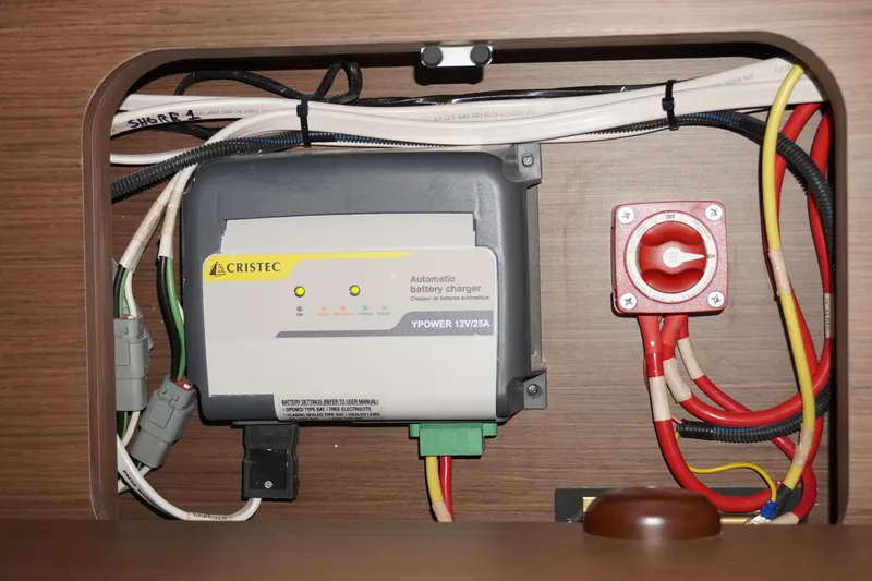 Slide: The Image of Battery charger and wiring inside 2024 Jeanneau NC Sport 895 boat. - 29