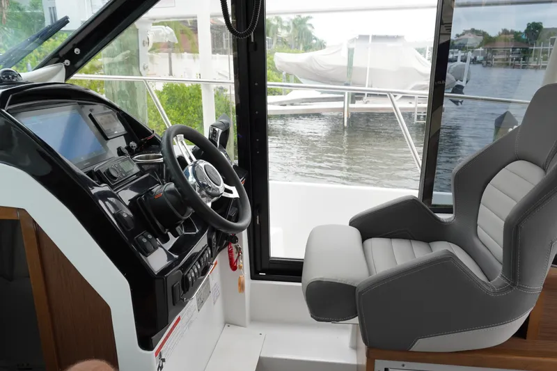 Slide: The Image of Interior view of 2024 Jeanneau NC Sport 895 helm with modern controls and comfortable seating. - 22
