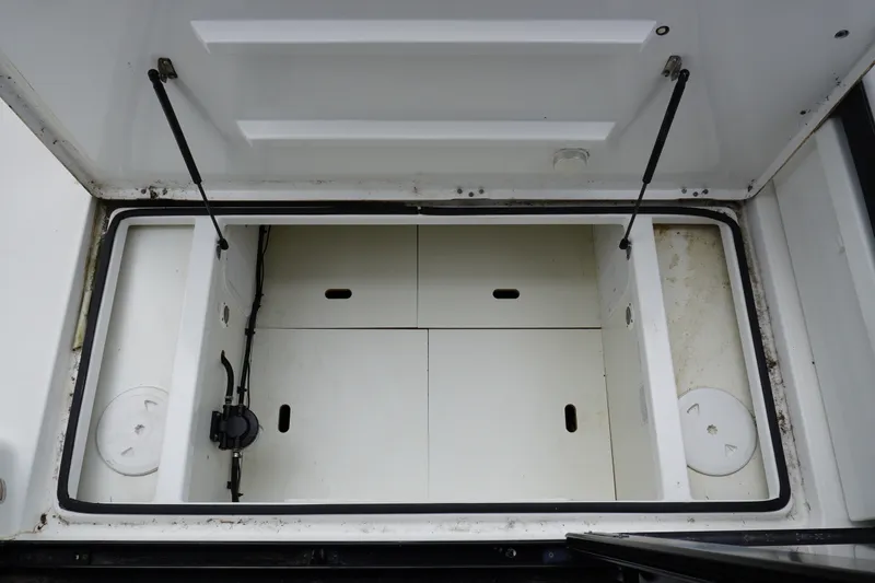 Slide: The Image of 2024 Jeanneau NC Sport 895 storage compartment with hydraulic supports and organized interior layout. - 26