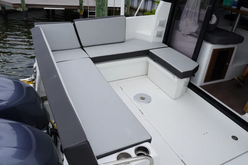 Slide: The Image of 2024 Jeanneau NC Sport 895 boat with spacious seating and dual outboard engines. - 23