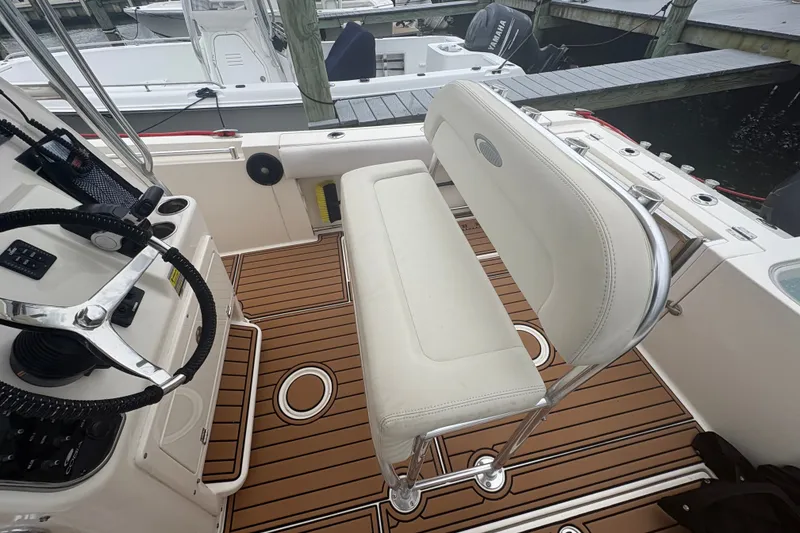 Slide: The Image of 2014 Cobia 237 Center Console boat interior with helm and seating area. - 6