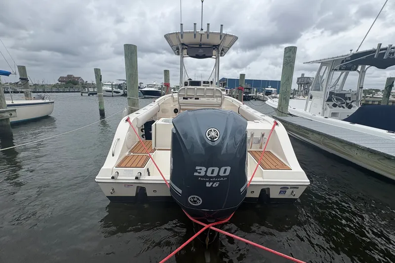 Slide: The Image of 2014 Cobia 237 Center Console boat docked with Yamaha 300 V6 engine. - 3