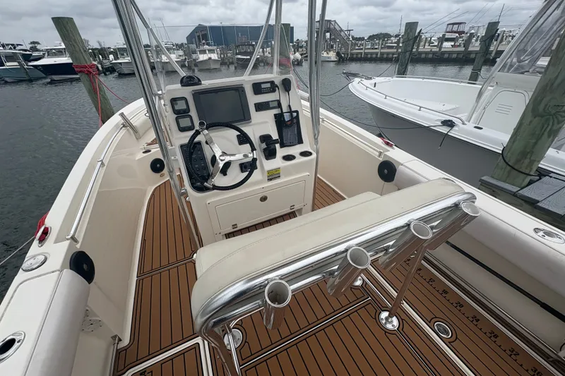 Slide: The Image of 2014 Cobia 237 Center Console boat interior with steering wheel and control panel. - 5