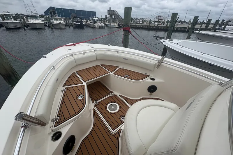 Slide: The Image of 2014 Cobia 237 Center Console boat with teak deck at marina. - 10