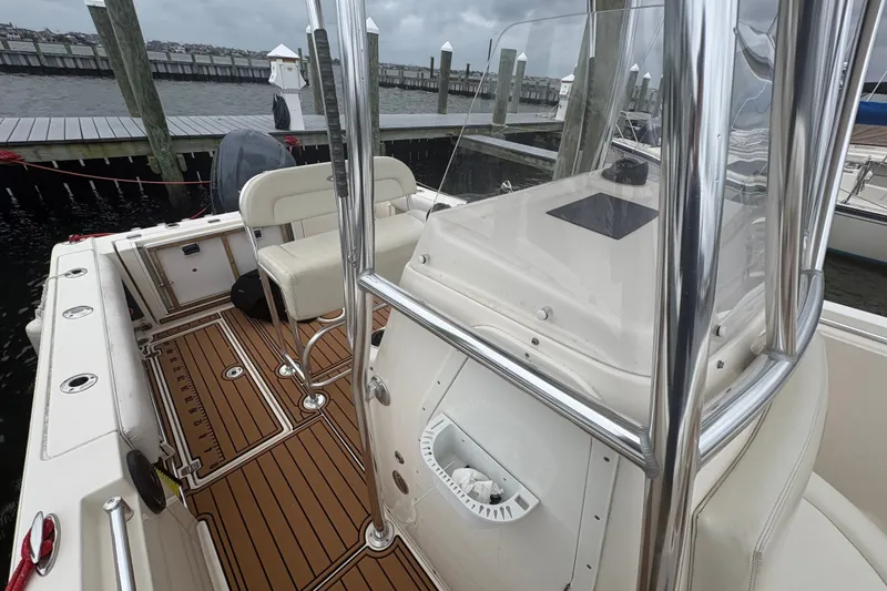 Slide: The Image of 2014 Cobia 237 Center Console boat interior with seating and polished metal rails. - 11