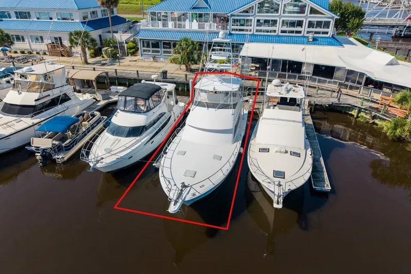 Slide: The Image of Aerial view of a 2000 Hatteras 55 Convertible yacht docked at a marina. - 5