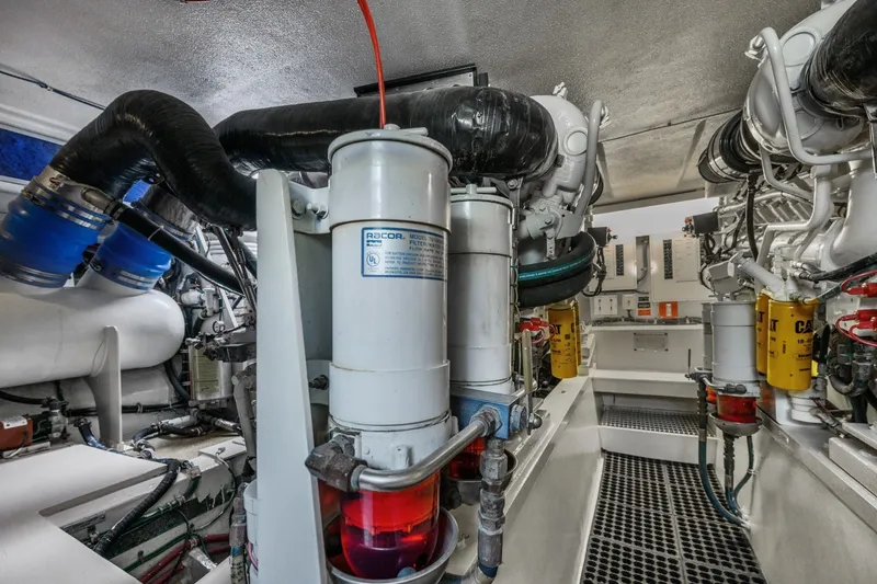 Slide: The Image of Engine room of 2000 Hatteras 55 Convertible yacht, showcasing mechanical components and filters. - 40
