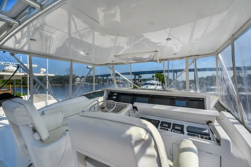 Slide: The Image of Interior view of 2000 Hatteras 55 Convertible yacht cockpit with steering and controls. - 11