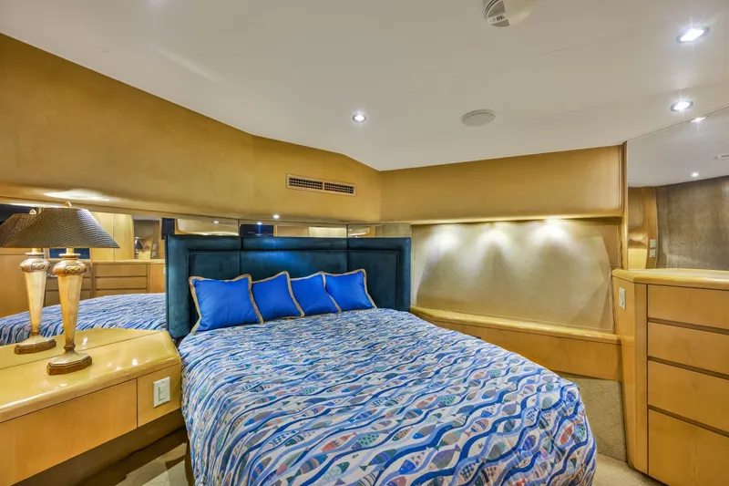 Slide: The Image of Luxurious bedroom interior of 2000 Hatteras 55 Convertible yacht with elegant bedding and lighting. - 26