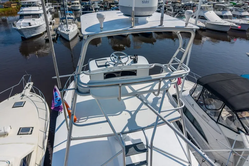 Slide: The Image of Aerial view of a 2000 Hatteras 55 Convertible yacht docked in a marina. - 7