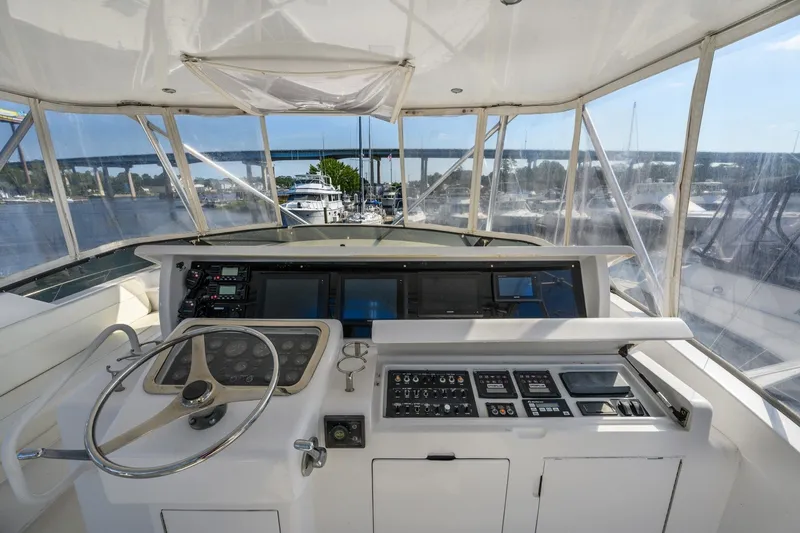 Slide: The Image of Helm of 2000 Hatteras 55 Convertible yacht with navigation controls and panoramic view. - 9