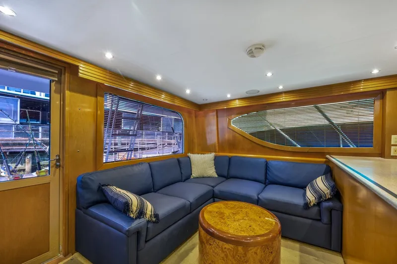 Slide: The Image of Luxurious interior of 2000 Hatteras 55 Convertible yacht with blue seating and wooden accents. - 18