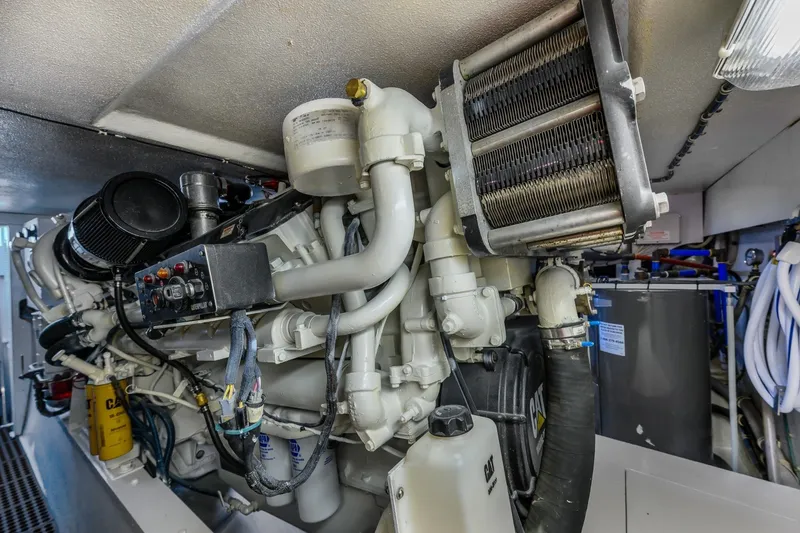 Slide: The Image of Engine room of a 2000 Hatteras 55 Convertible yacht, showcasing detailed machinery. - 39