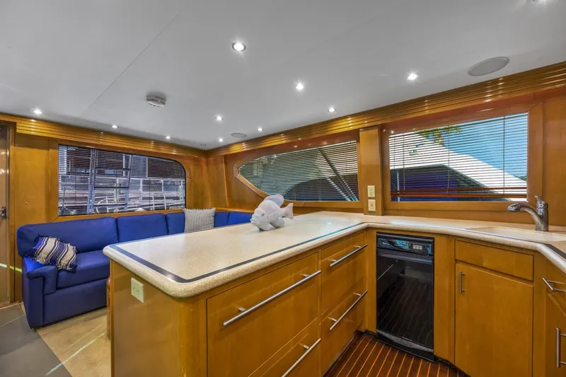 Slide: The Image of Luxurious interior of 2000 Hatteras 55 Convertible yacht with modern kitchen and seating area. - 24