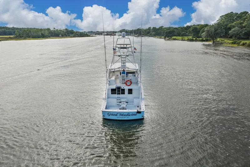 Slide: The Image of Hatteras 55 Convertible yacht cruising on a scenic river, 2000 model. - 4
