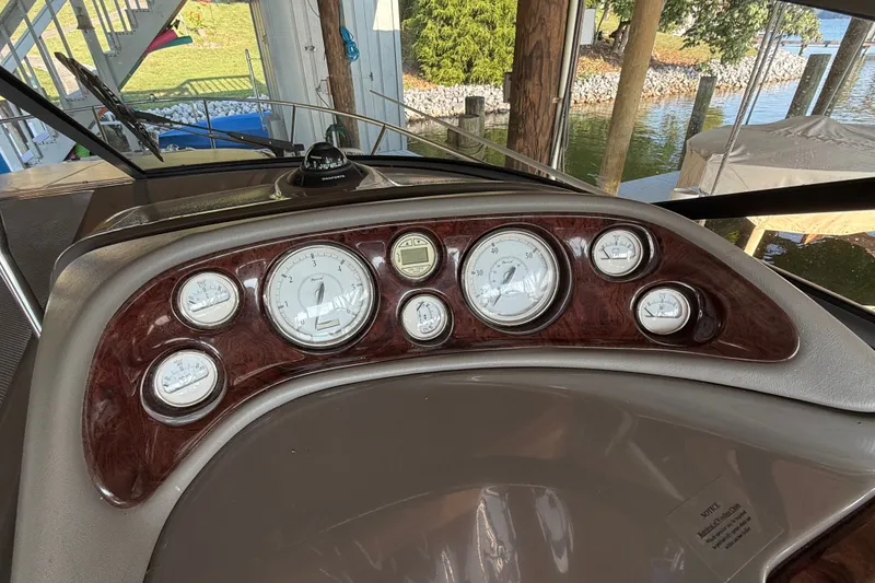 Slide: The Image of Dashboard of a 2007 Regal Commodore 2665 boat with gauges and compass. - 15