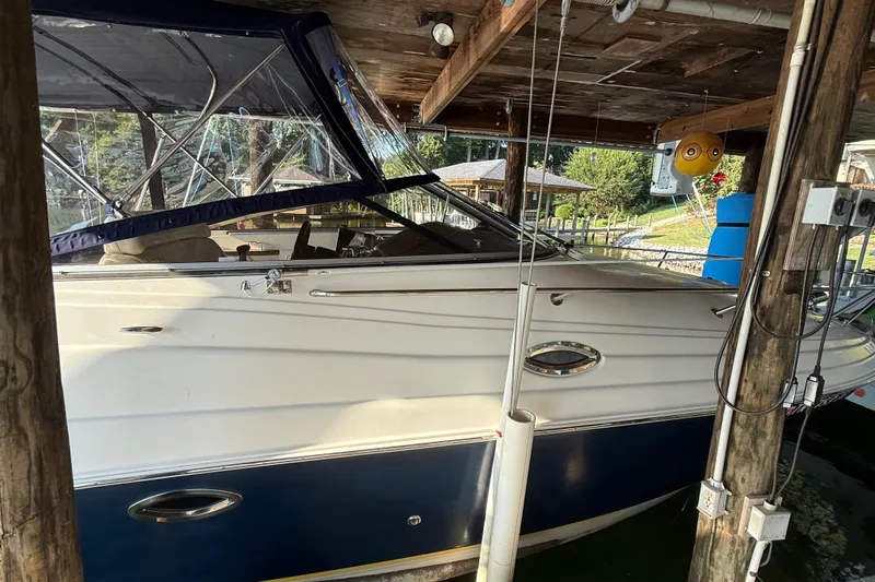 Slide: The Image of 2007 Regal Commodore 2665 boat docked under wooden shelter. - 9