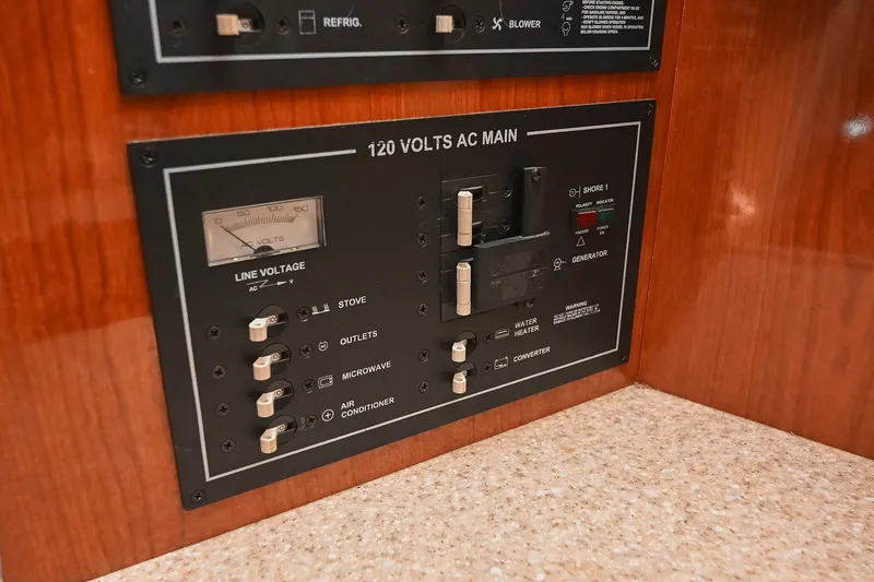 Slide: The Image of Electrical panel of a 2007 Regal Commodore 2665 boat, featuring 120 volts AC main controls. - 44