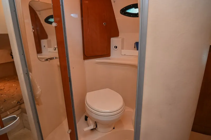 Slide: The Image of 2007 Regal Commodore 2665 boat bathroom with toilet and wooden cabinetry. - 35
