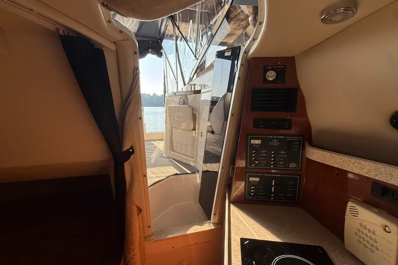 Slide: The Image of Interior view of 2007 Regal Commodore 2665 boat with control panels and open cabin door. - 25