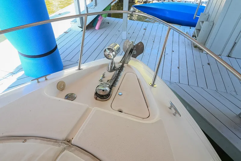 Slide: The Image of Bow of 2007 Regal Commodore 2665 boat with anchor and railing in docked position. - 42