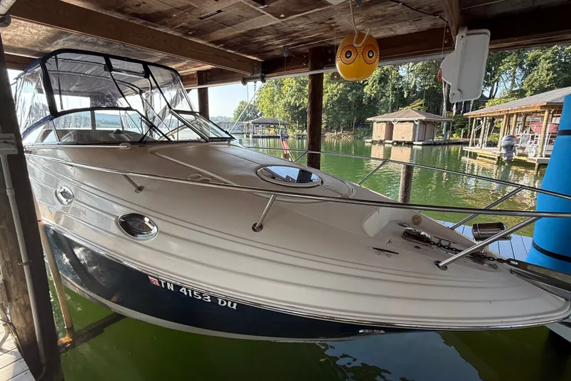 Slide: The Image of 2007 Regal Commodore 2665 boat docked in a serene lakeside setting. - 8