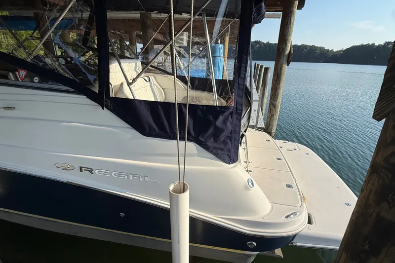 Slide: The Image of 2007 Regal Commodore 2665 boat docked by a serene lake. - 5