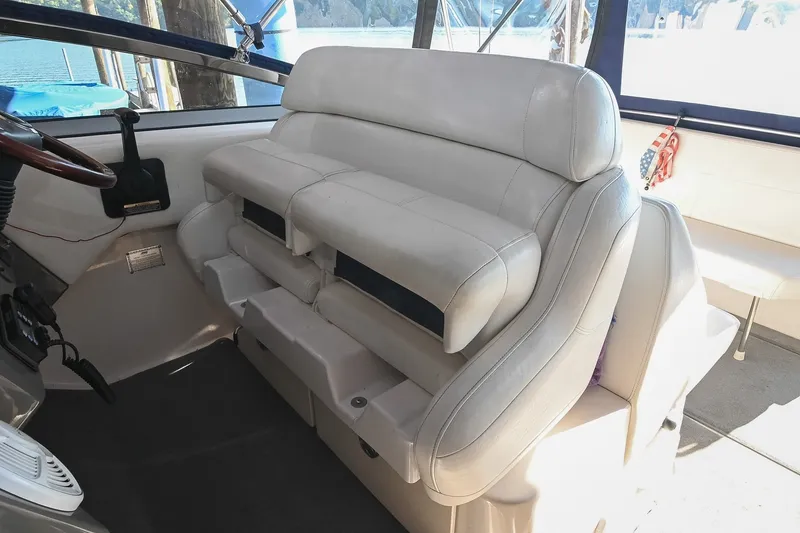Slide: The Image of Interior of 2007 Regal Commodore 2665 boat with white leather seating and steering wheel. - 23