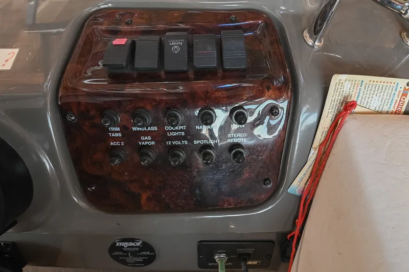Slide: The Image of Control panel of a 2007 Regal Commodore 2665 boat with various switches. - 22