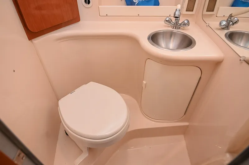 Slide: The Image of Compact bathroom in 2007 Regal Commodore 2665 boat with toilet and sink. - 36