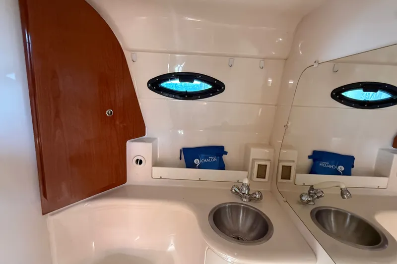 Slide: The Image of 2007 Regal Commodore 2665 bathroom with sink, mirror, and wooden cabinet. - 26