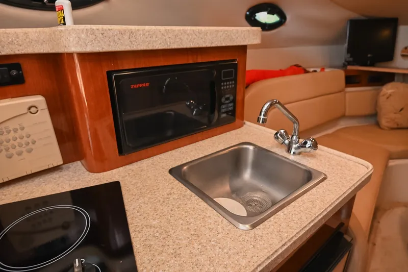 Slide: The Image of 2007 Regal Commodore 2665 yacht interior with kitchenette, sink, and microwave. - 27