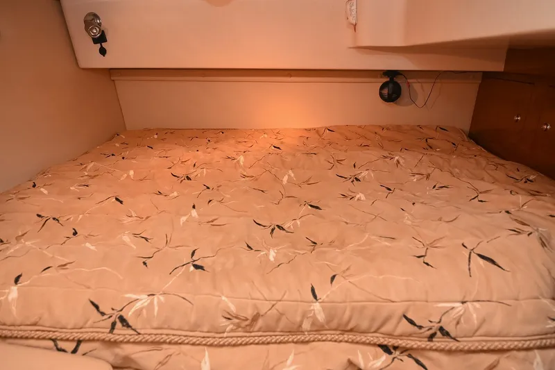 Slide: The Image of Cozy cabin bed in 2007 Regal Commodore 2665 boat, featuring floral-patterned bedding. - 39