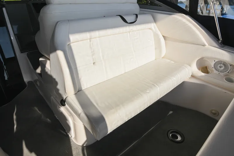 Slide: The Image of Interior seating of 2007 Regal Commodore 2665 boat, featuring white upholstery and built-in speaker. - 13