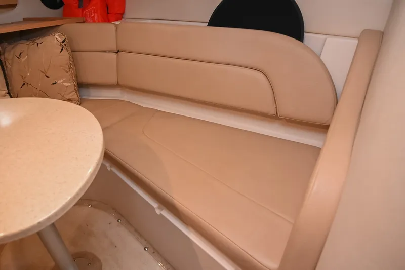 Slide: The Image of Interior of 2007 Regal Commodore 2665 boat with beige seating and table. - 32