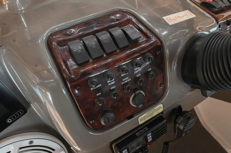 Slide: The Image of Control panel of a 2007 Regal Commodore 2665 boat with labeled switches and dials. - 21