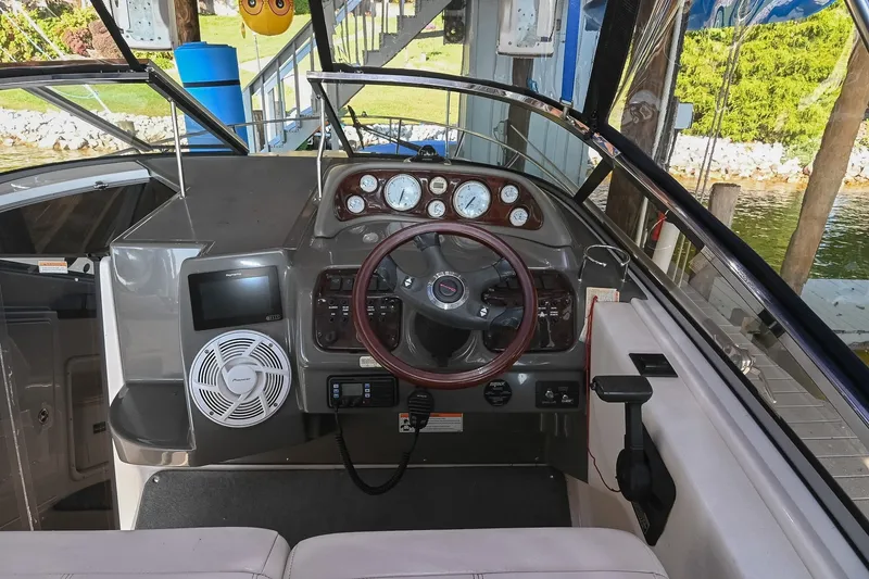 Slide: The Image of 2007 Regal Commodore 2665 boat cockpit with steering wheel and control panel. - 18