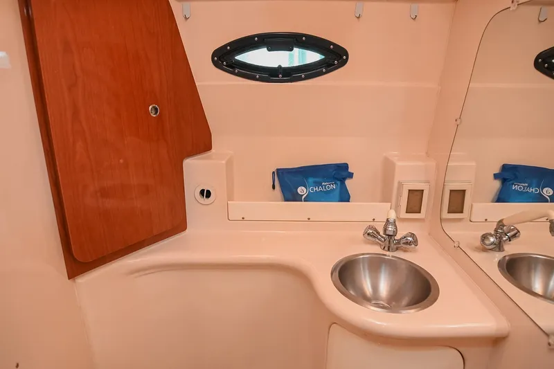 Slide: The Image of 2007 Regal Commodore 2665 boat bathroom with sink, mirror, and storage cabinet. - 37