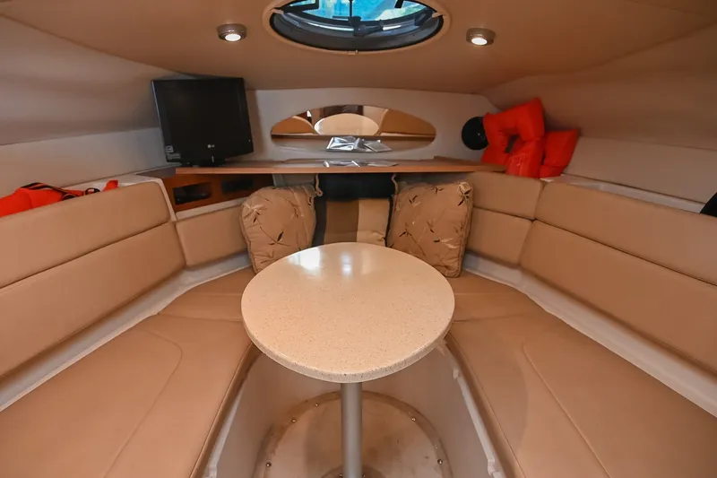 Slide: The Image of Interior of 2007 Regal Commodore 2665 boat with beige seating and round table. - 29