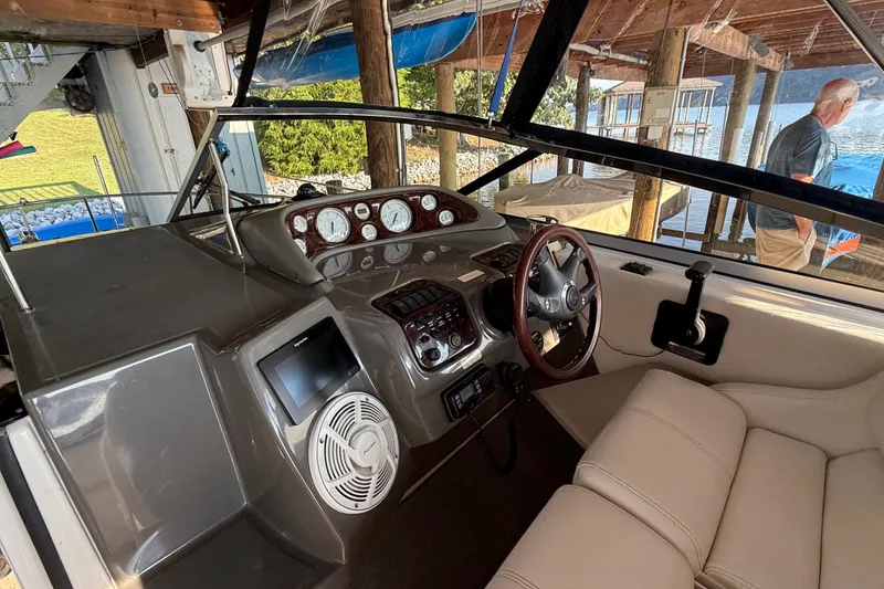 Slide: The Image of 2007 Regal Commodore 2665 boat interior with steering wheel and dashboard controls. - 13