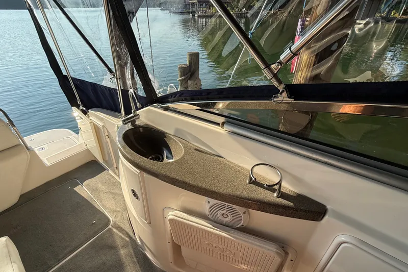 Slide: The Image of 2007 Regal Commodore 2665 boat interior with sink and lake view. - 17