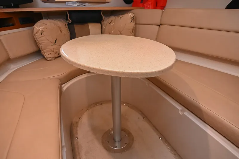 Slide: The Image of Interior of 2007 Regal Commodore 2665 boat with beige seating and round table. - 31