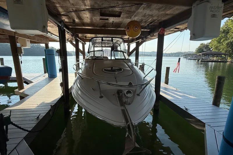 The Image of 2007 Regal Commodore 2665 boat docked in a covered marina on a sunny day. - 6