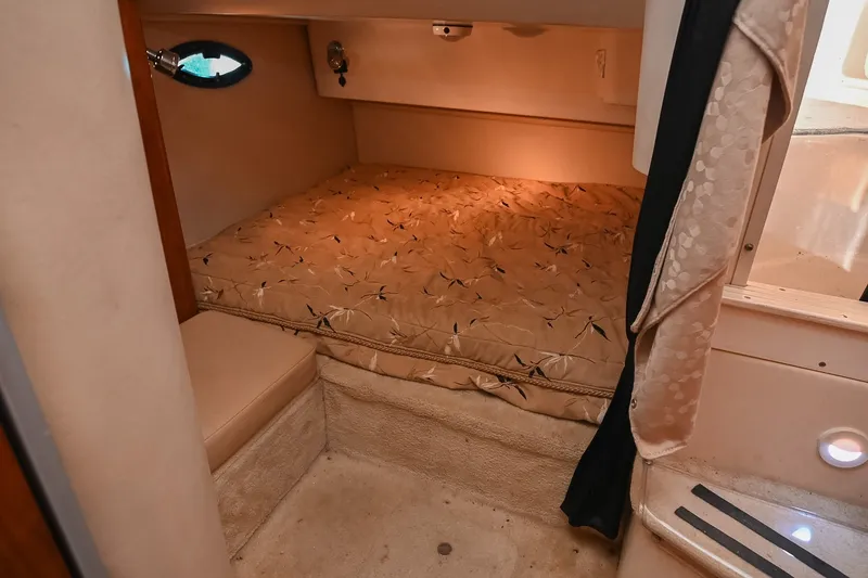 Slide: The Image of Cozy cabin interior of 2007 Regal Commodore 2665 with patterned bedding and ambient lighting. - 38